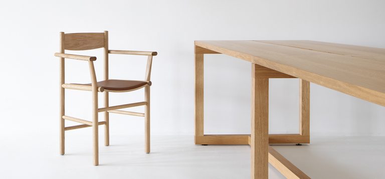 Akademia chair with armrests featuring curved seat and straight frame by Kaksikko for Nikari