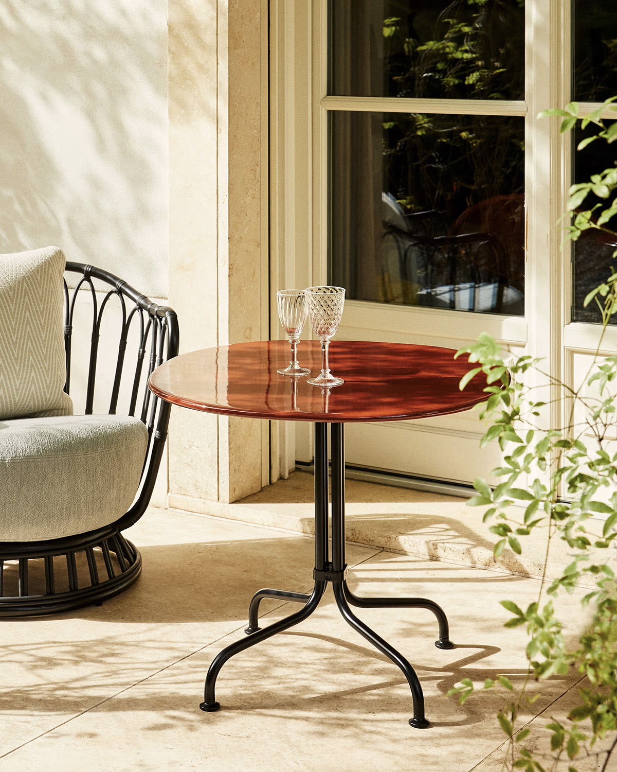 Gubi's Carmel Bistro Table collection in both dining and lounge heights, displaying the California-inspired design in Red Rock and Clam White glazed Italian stoneware finishes.