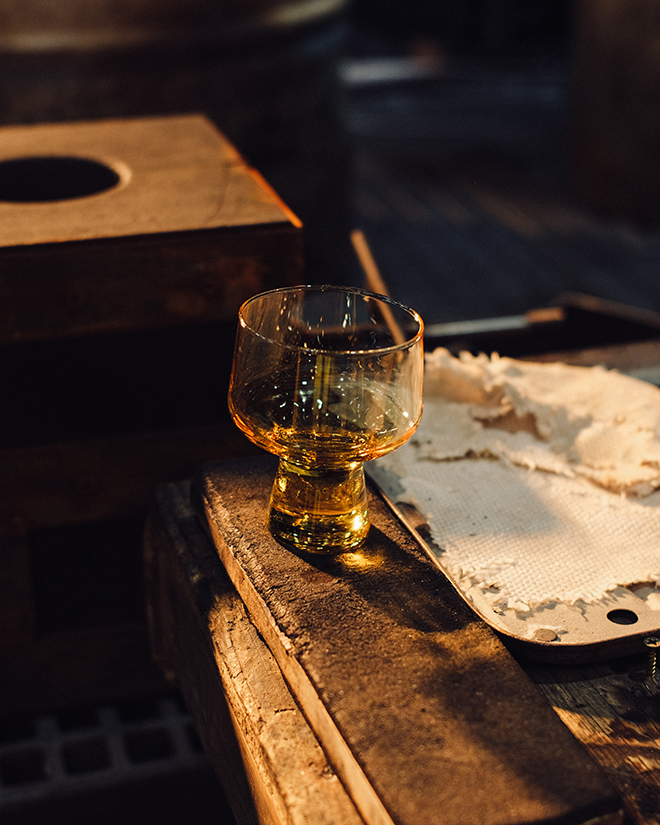 Iittala craftsperson mouth-blowing molten glass at 1450°C to create a Solare piece, demonstrating the traditional techniques behind the contemporary collection.