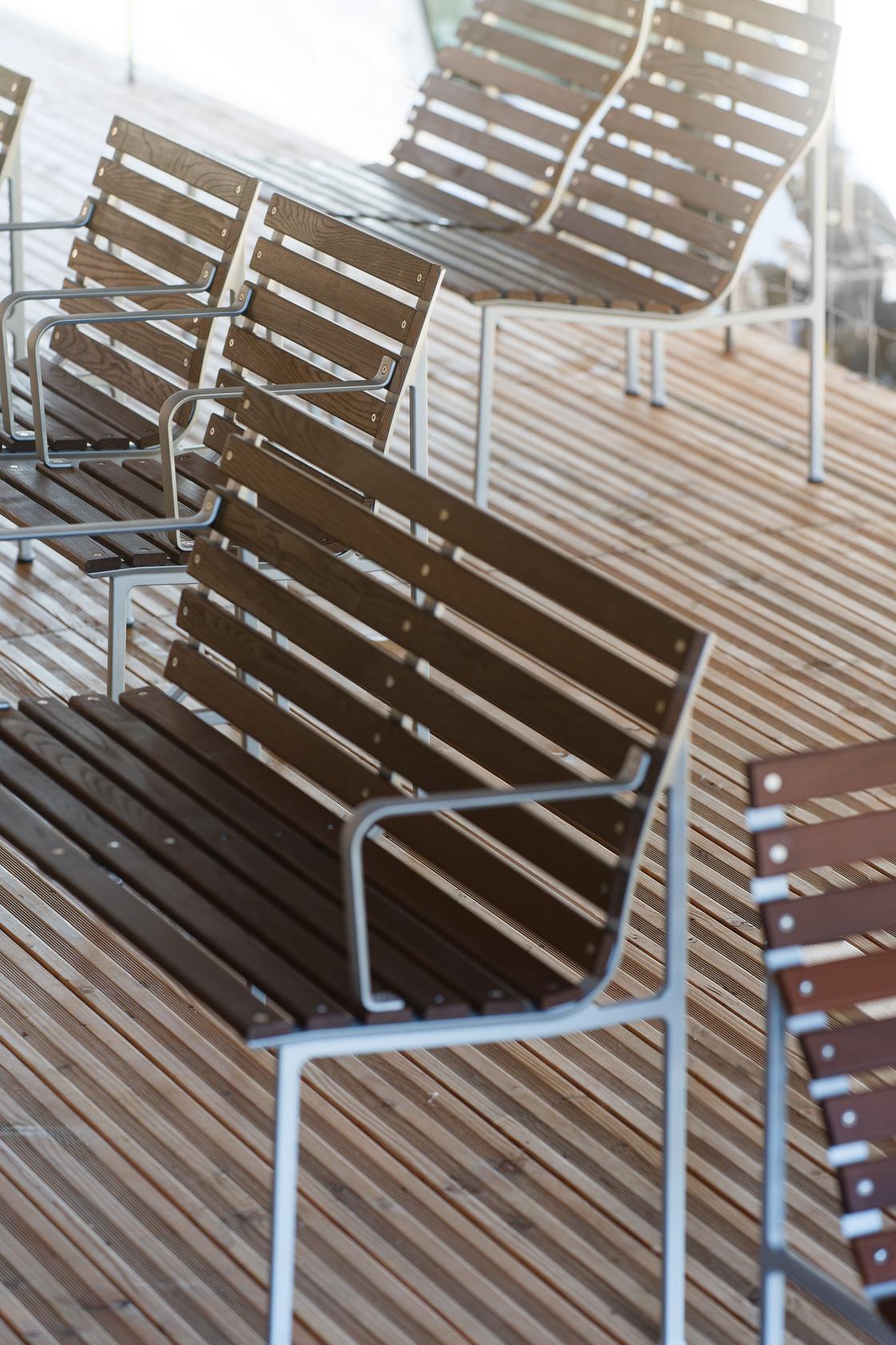 Erwan Bouroullec's Traverse bench with heat-treated ash slats in public garden setting