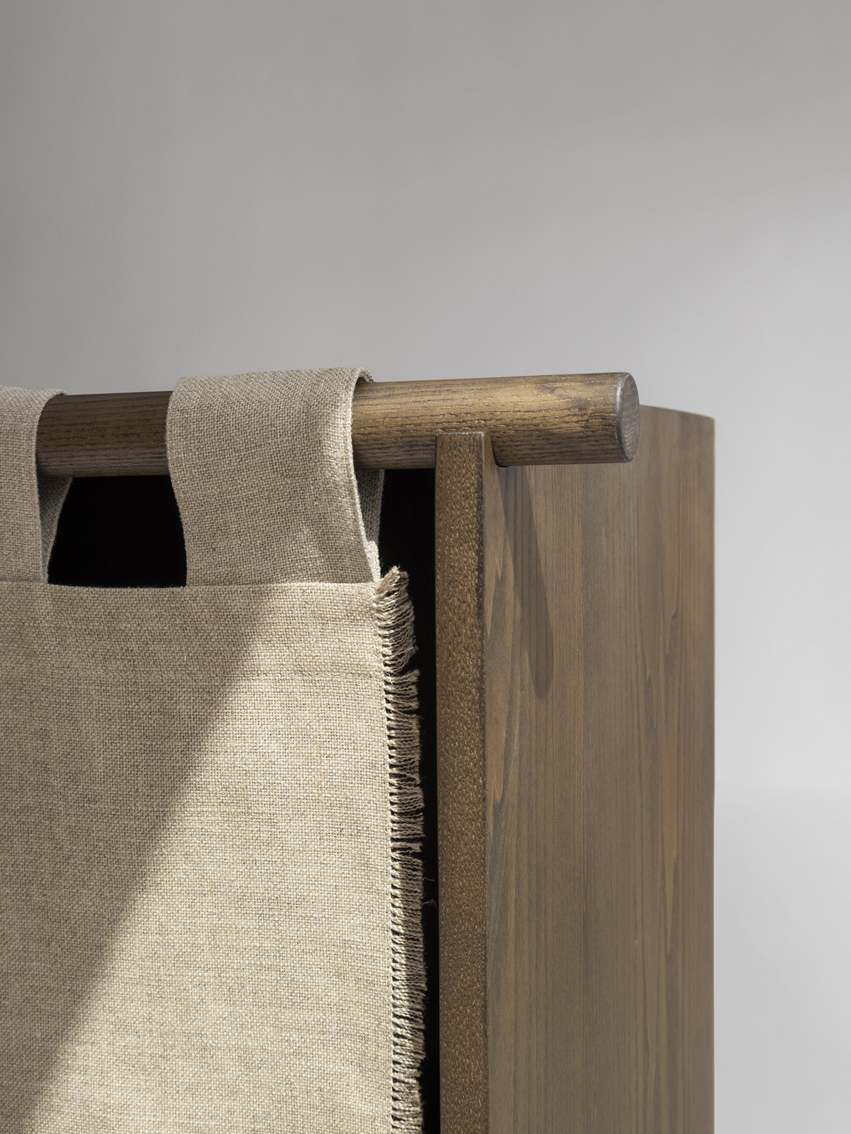 Close-up detail of the Veil Cabinet's natural linen door panel and elegant joinery, highlighting Origin Made's quality craftsmanship.