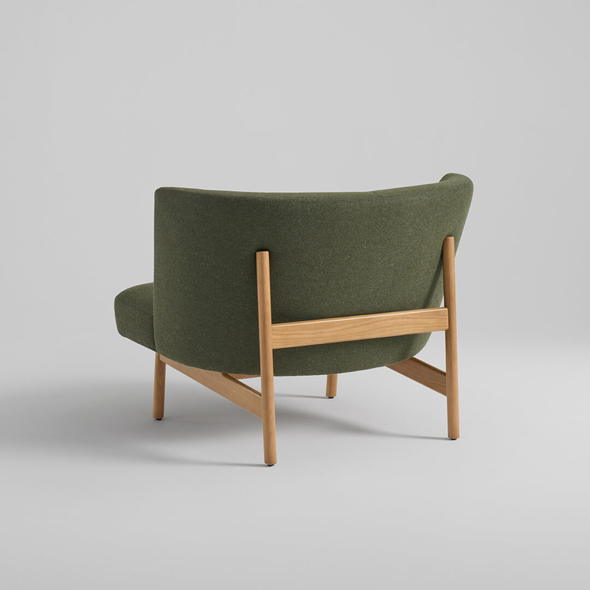 Arcata lounge chair by Anderssen & Voll for Davis showing curved silhouette with exposed oak wood base design