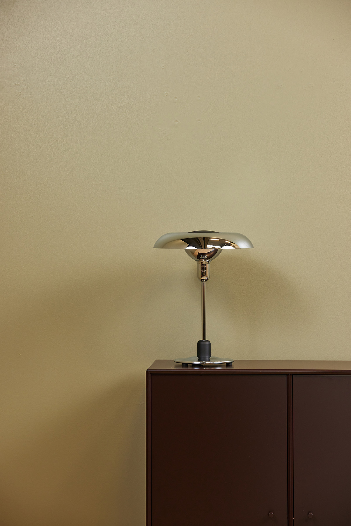 Piet Hein RA250 chrome lamp on designer desk creating focused work lighting with mathematical precision