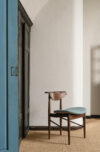 Finn Juhl's Reading Chair in pure American walnut finish showing distinctive Danish modern design aesthetic