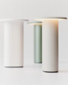 Solae portable lamp by Cecilie Manz for Fritz Hansen featuring oval aluminum base and circular LED top