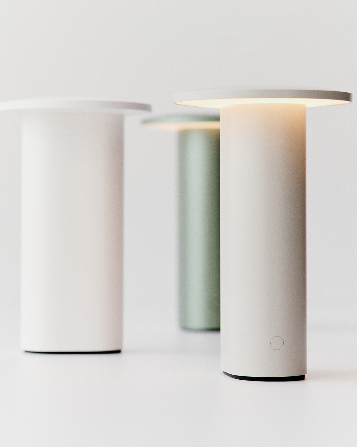 Solae portable lamp by Cecilie Manz for Fritz Hansen featuring oval aluminum base and circular LED top