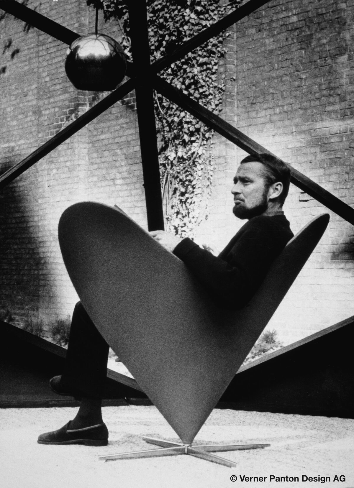 Verner Panton sitting in his own 1958 Heart Cone Chair design