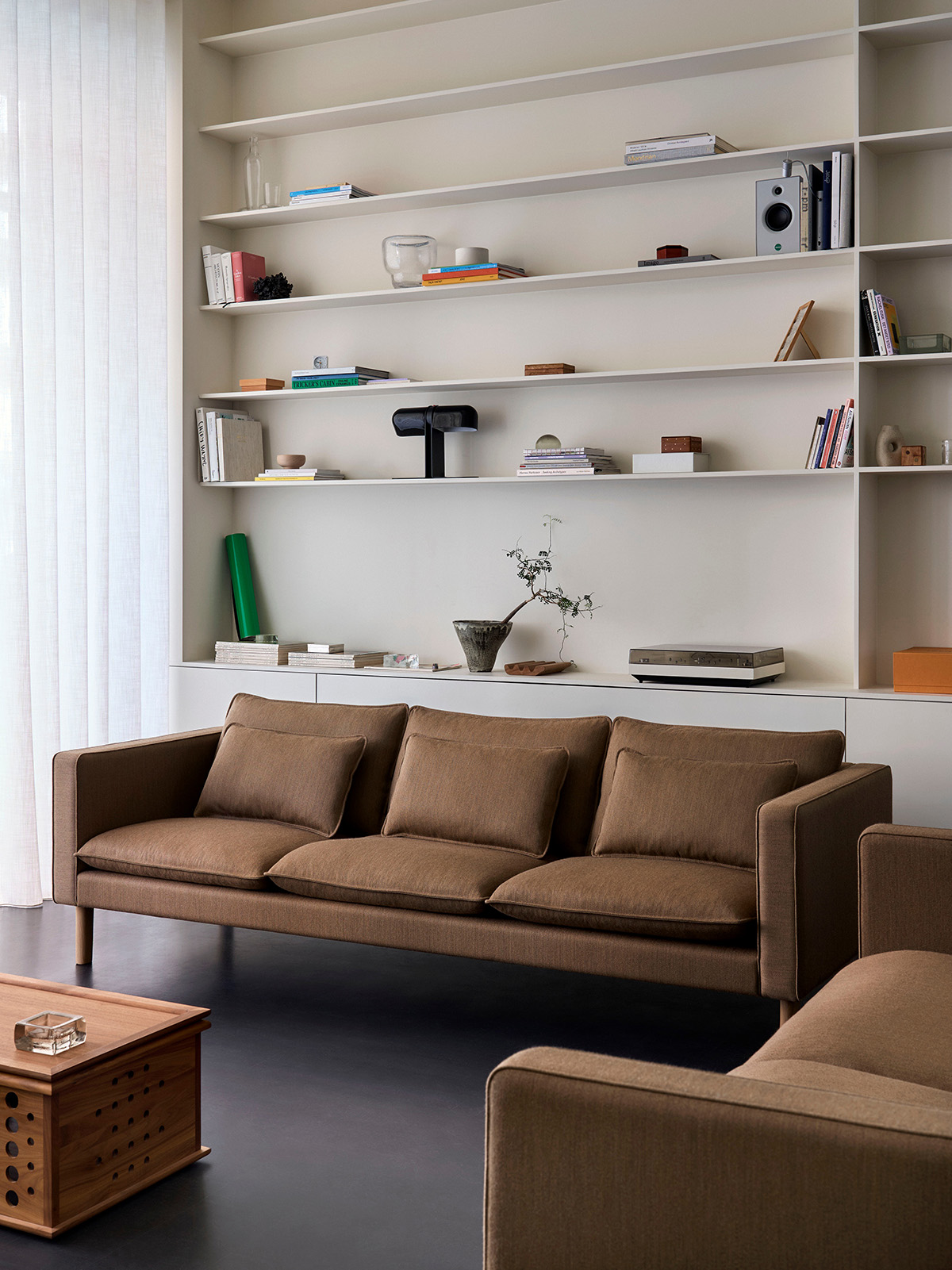 Refined upholstery detail of Jota Lounge sofa showing fabric weave, seating comfort proportions, and armrest form