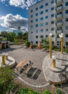 Island outdoor table and benches by Färg & Blanche for Nola in a residential courtyard
